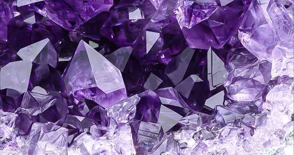 Close-up of purple quartz crystal points in a druse